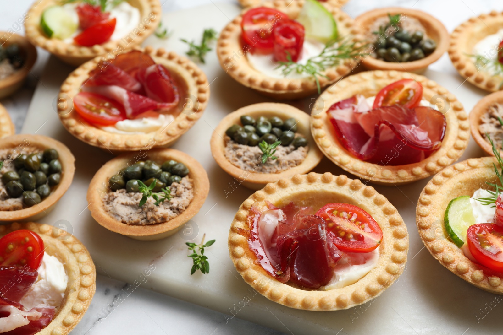 Photo of Different delicious canapes on white table, closeup