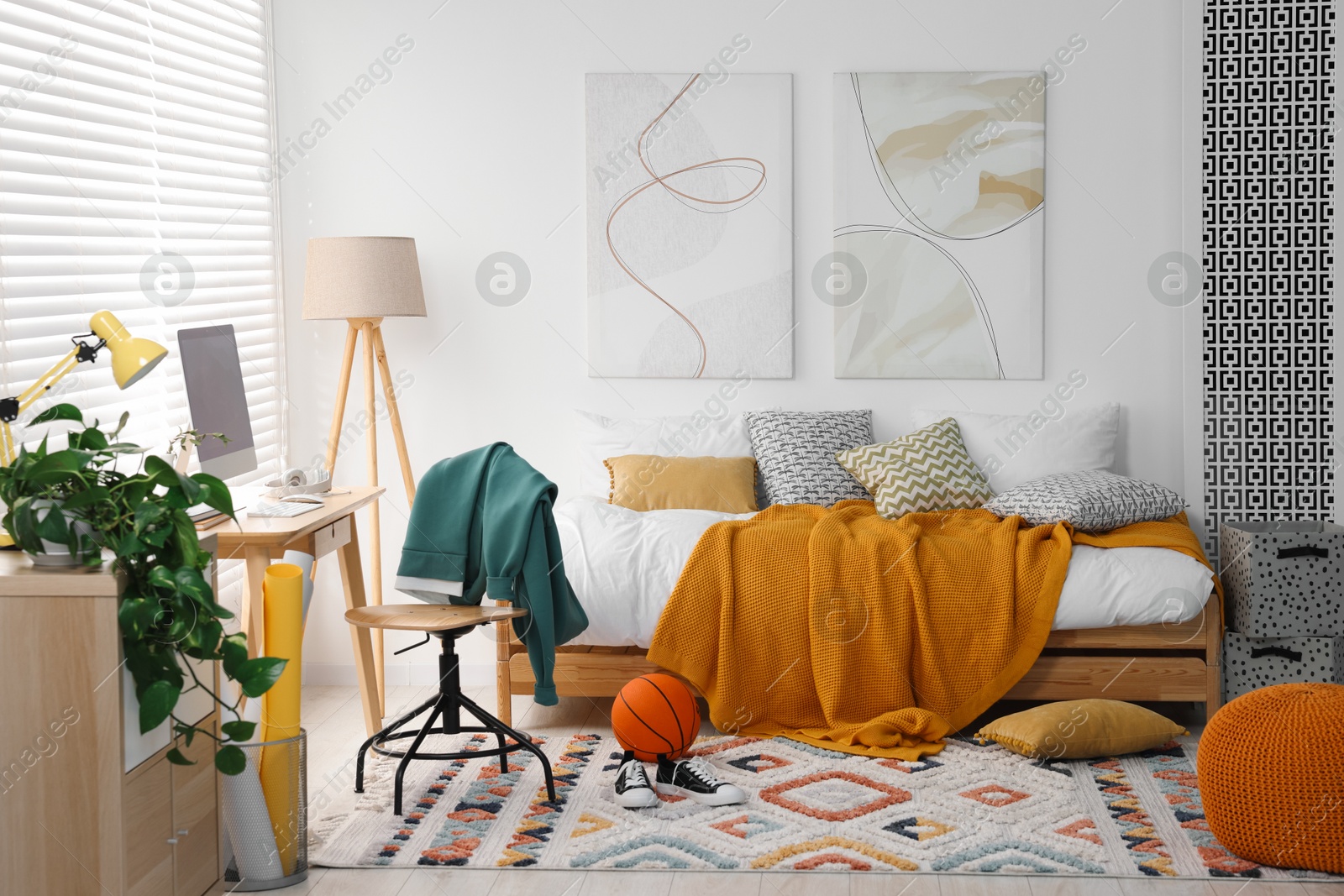 Photo of Teen's room interior with modern furniture and beautiful pictures on wall