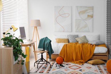 Teen's room interior with modern furniture and beautiful pictures on wall