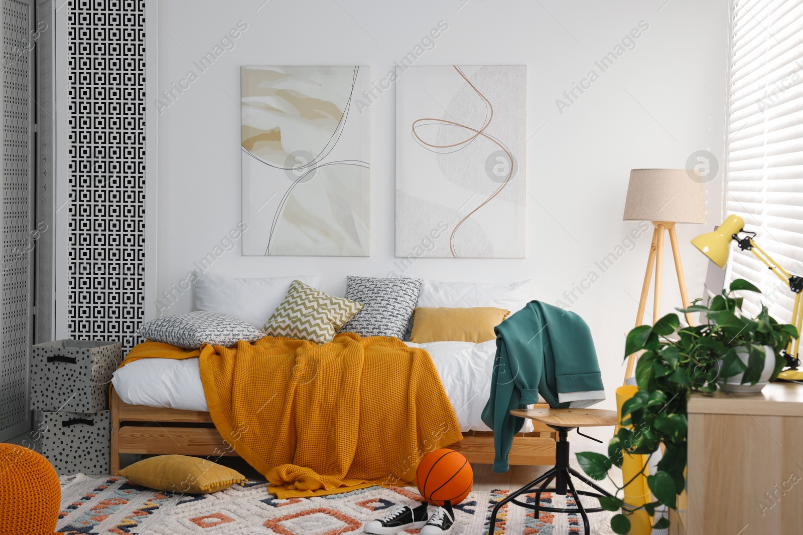 Photo of Teen's room interior with modern furniture and beautiful pictures on wall