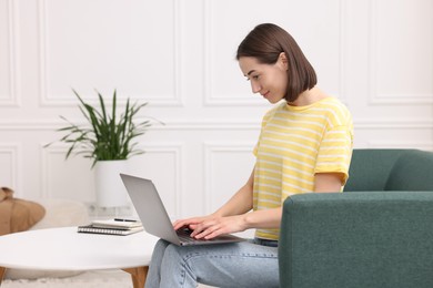 Woman with good posture using laptop at home