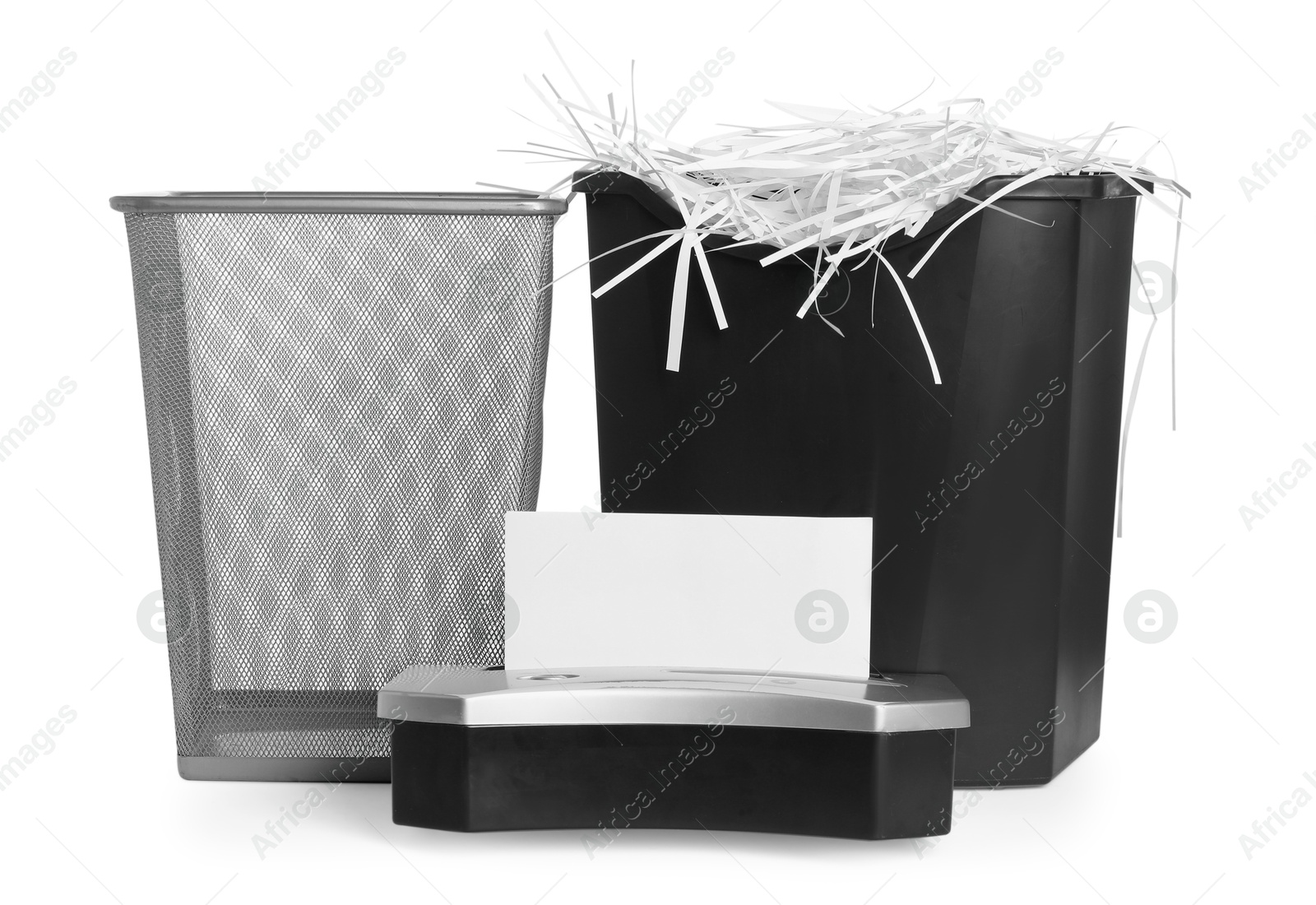 Photo of Shredder, metal basket and paper strips on white background