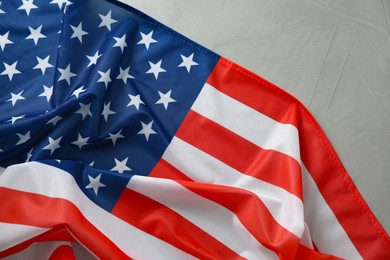 Photo of Flag of USA on light grey table, top view