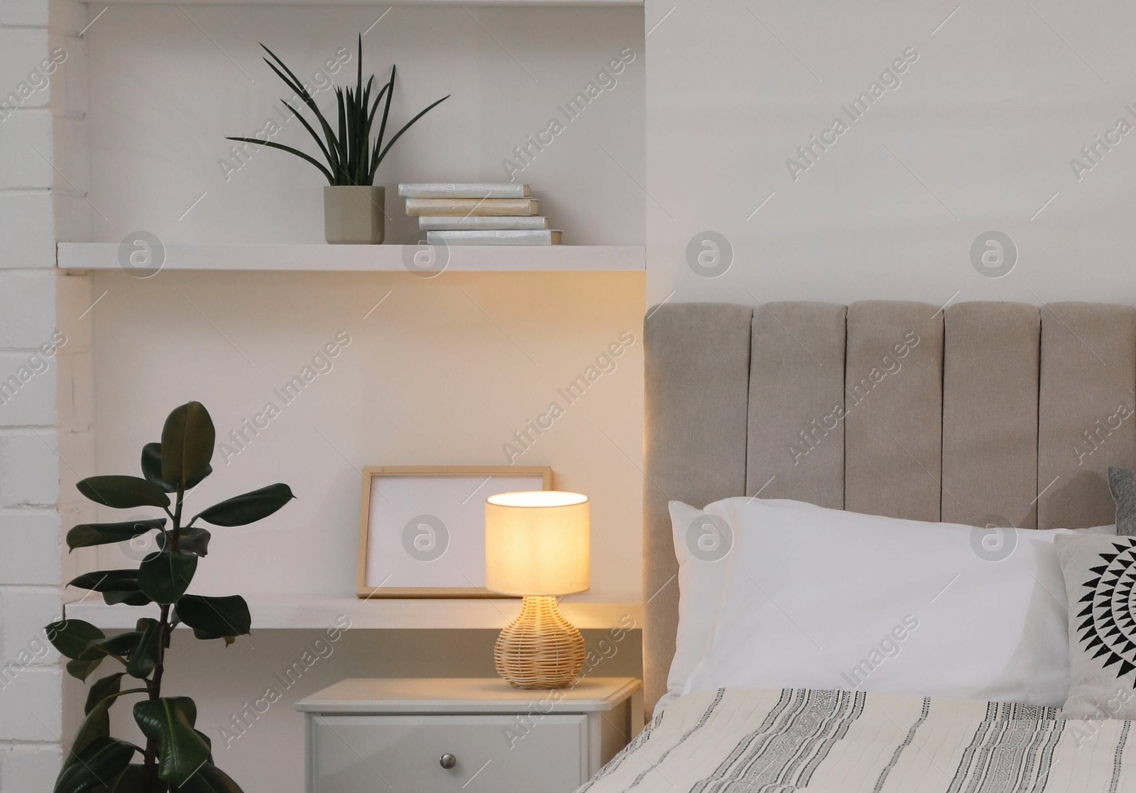 Photo of Stylish contemporary bedroom interior with houseplants and comfortable bed