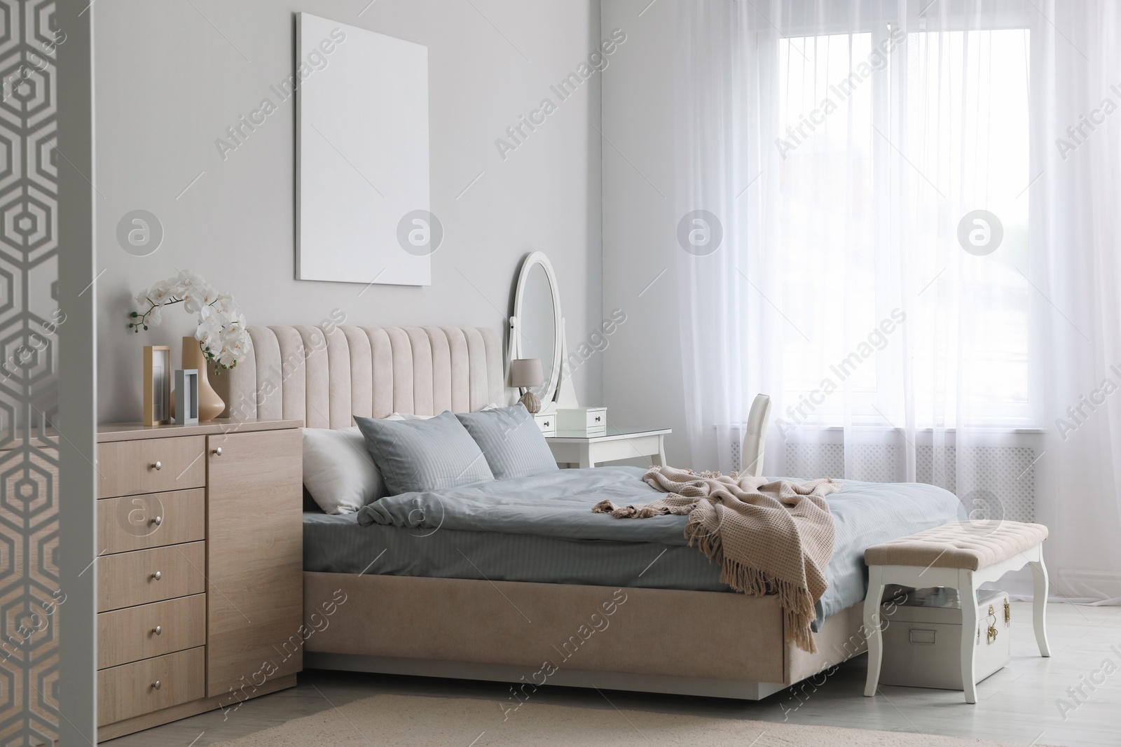 Photo of Stylish contemporary bedroom interior with ottoman and comfortable bed