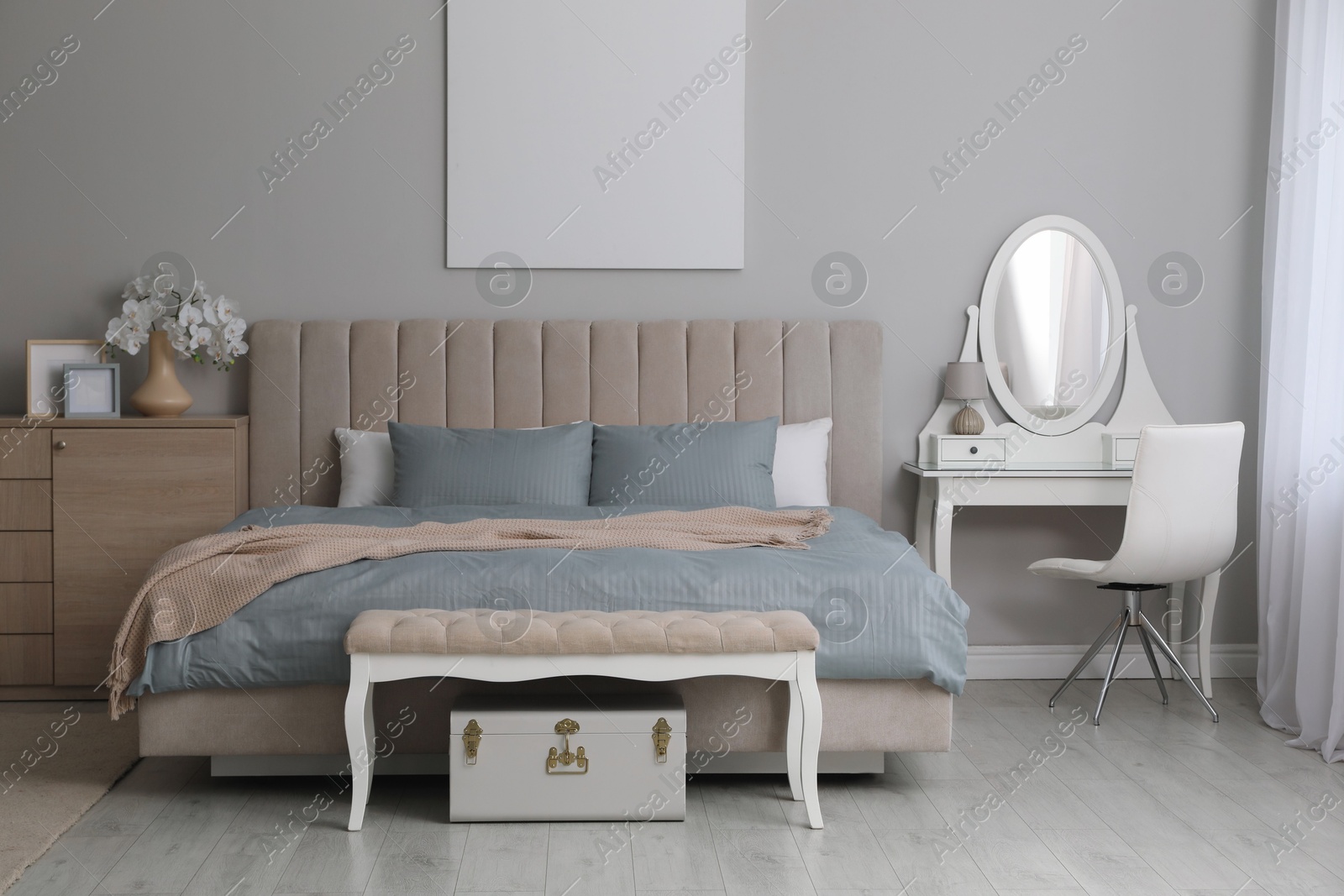 Photo of Stylish contemporary bedroom interior with ottoman and comfortable bed