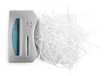 Shredder and paper strips isolated on white, top view