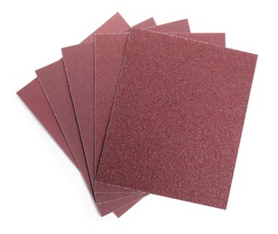 Photo of Sheets of sandpaper isolated on white, top view