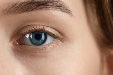 Woman with beautiful blue eyes, macro photo