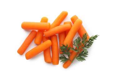 Photo of Many baby carrots and green leaf isolated on white, top view