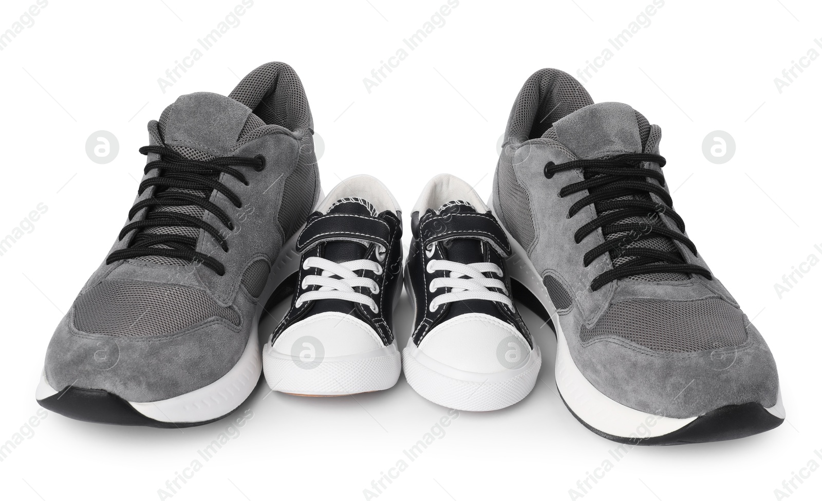 Photo of Big and small sneakers isolated on white