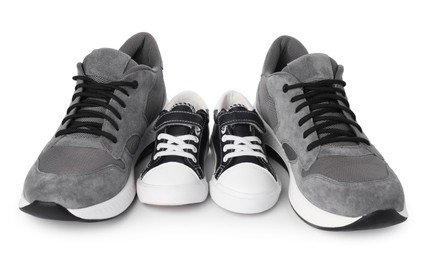 Photo of Big and small sneakers isolated on white