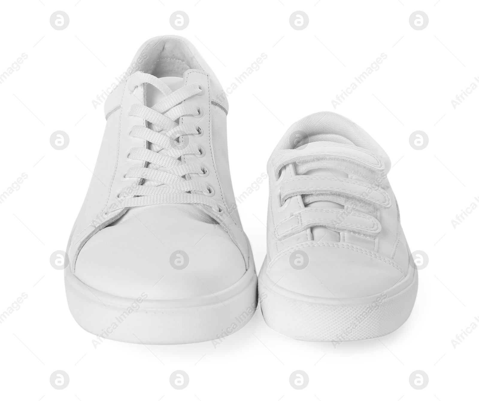 Photo of Big and small sneakers isolated on white