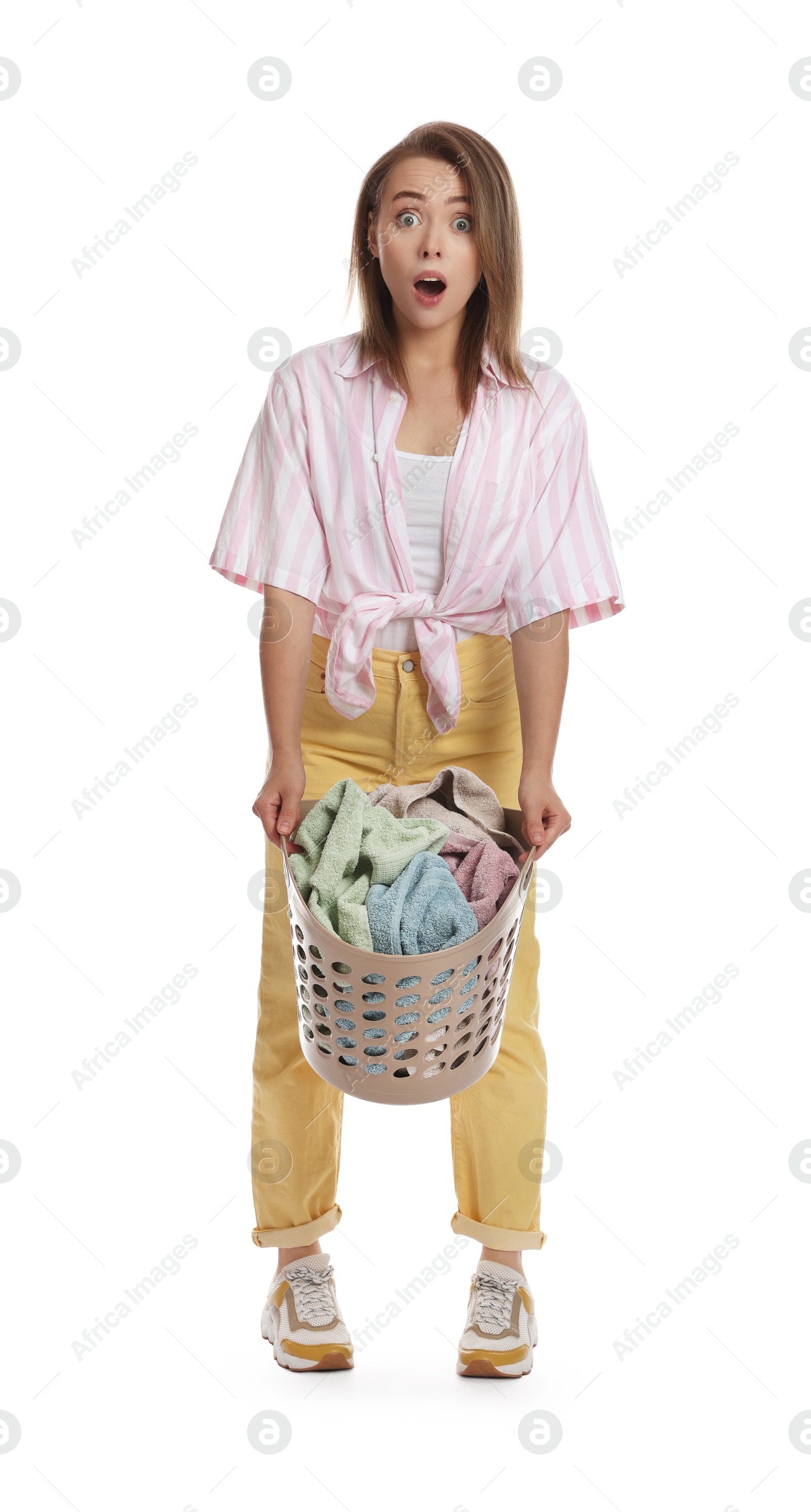 Photo of Emotional housewife with basket full of laundry on white background