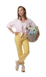 Photo of Happy young housewife with basket full of laundry on white background