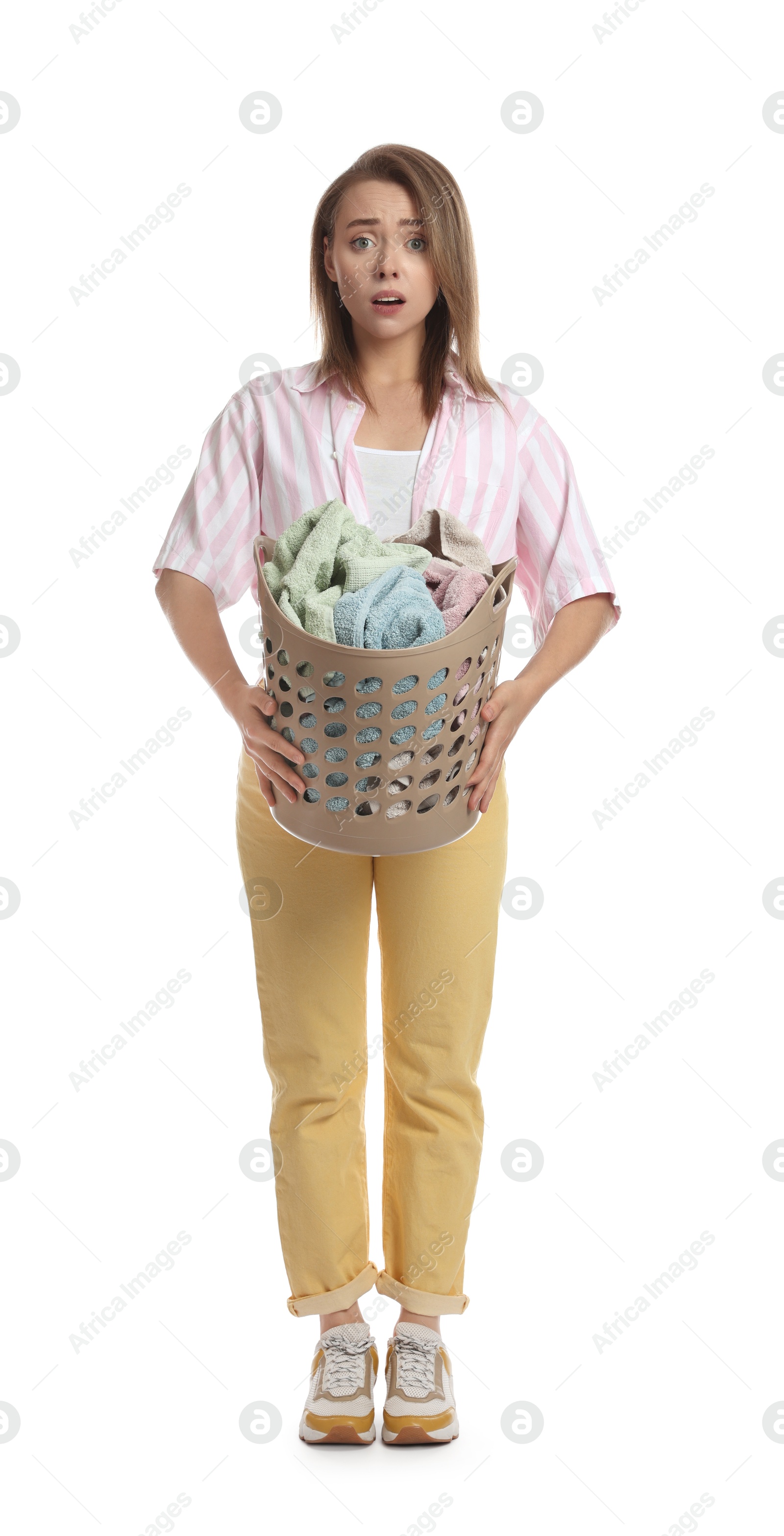 Photo of Tired housewife with basket full of laundry on white background