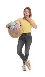 Emotional housewife with basket full of laundry on white background