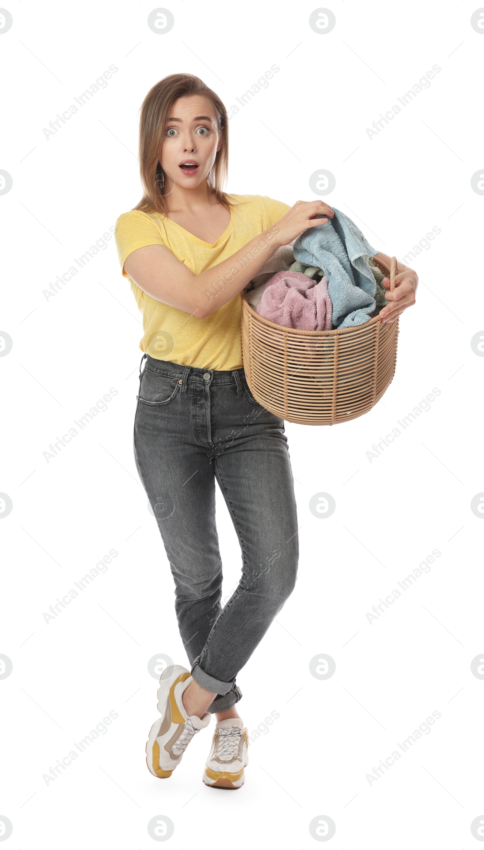 Photo of Emotional housewife with basket full of laundry on white background