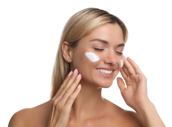 Beautiful woman with cream on her face against white background