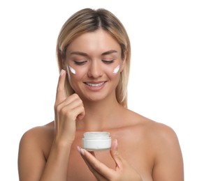 Beautiful woman applying face cream on white background