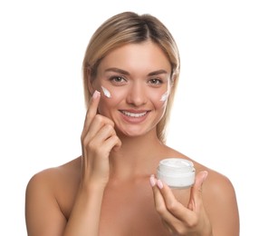 Beautiful woman applying face cream on white background