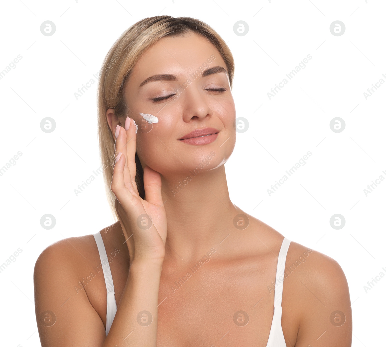 Photo of Beautiful woman applying face cream on white background