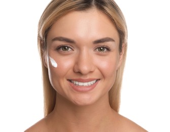 Beautiful woman with cream on her face against white background