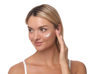 Beautiful woman with cream on her face against white background