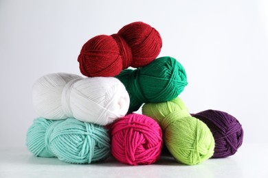 Photo of Many soft skeins of yarn on light grey background