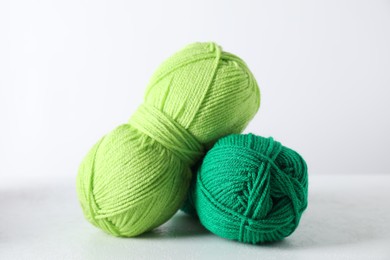 Two soft skeins of yarn on light grey background