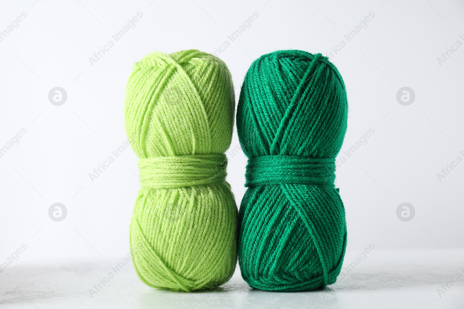 Photo of Two soft skeins of yarn on light grey background