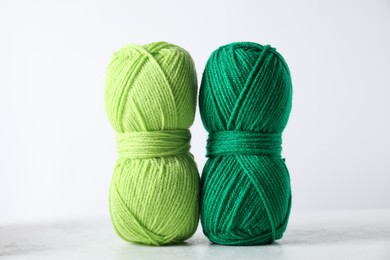 Two soft skeins of yarn on light grey background