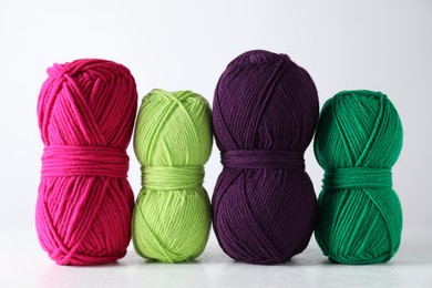 Photo of Many soft skeins of yarn on light grey background