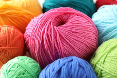 Photo of Many soft skeins of yarn on light grey background, closeup