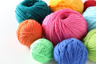 Photo of Many soft skeins of yarn on light grey background, closeup