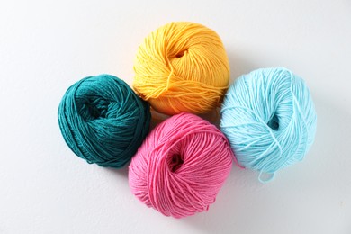 Photo of Many soft skeins of yarn on light grey background, flat lay