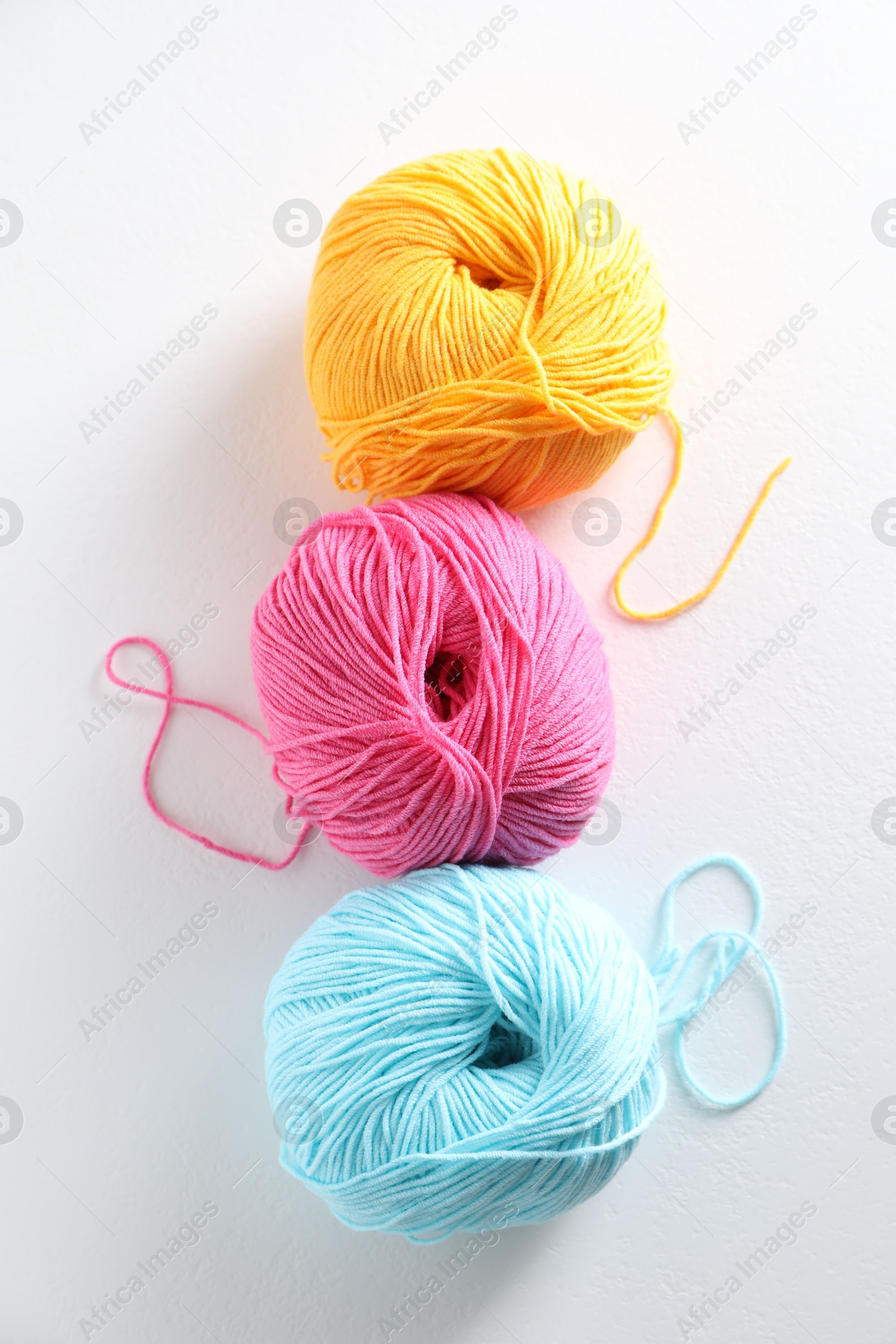 Photo of Many soft skeins of yarn on light grey background, flat lay