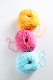 Photo of Many soft skeins of yarn on light grey background, flat lay