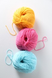 Photo of Many soft skeins of yarn on light grey background, flat lay