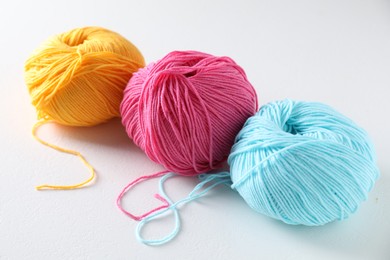 Many soft skeins of yarn on light grey background