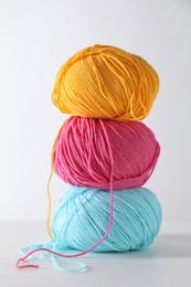 Many soft skeins of yarn on light grey background