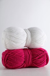 Photo of Two soft skeins of yarn on light grey background