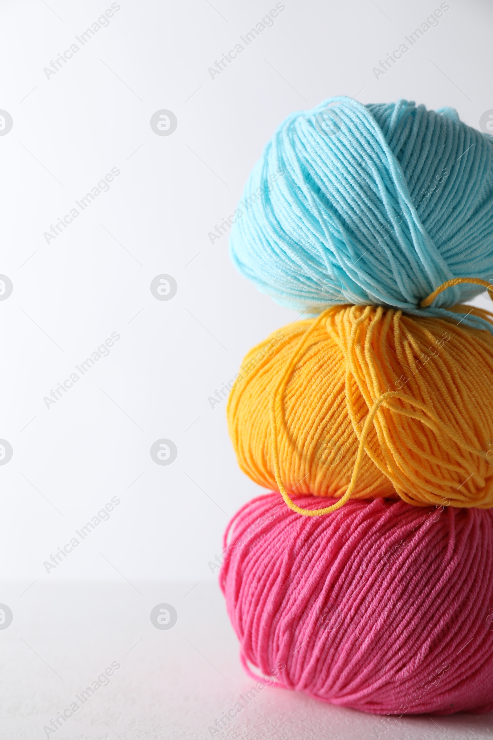 Photo of Many soft skeins of yarn on light grey background