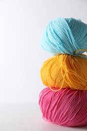 Many soft skeins of yarn on light grey background