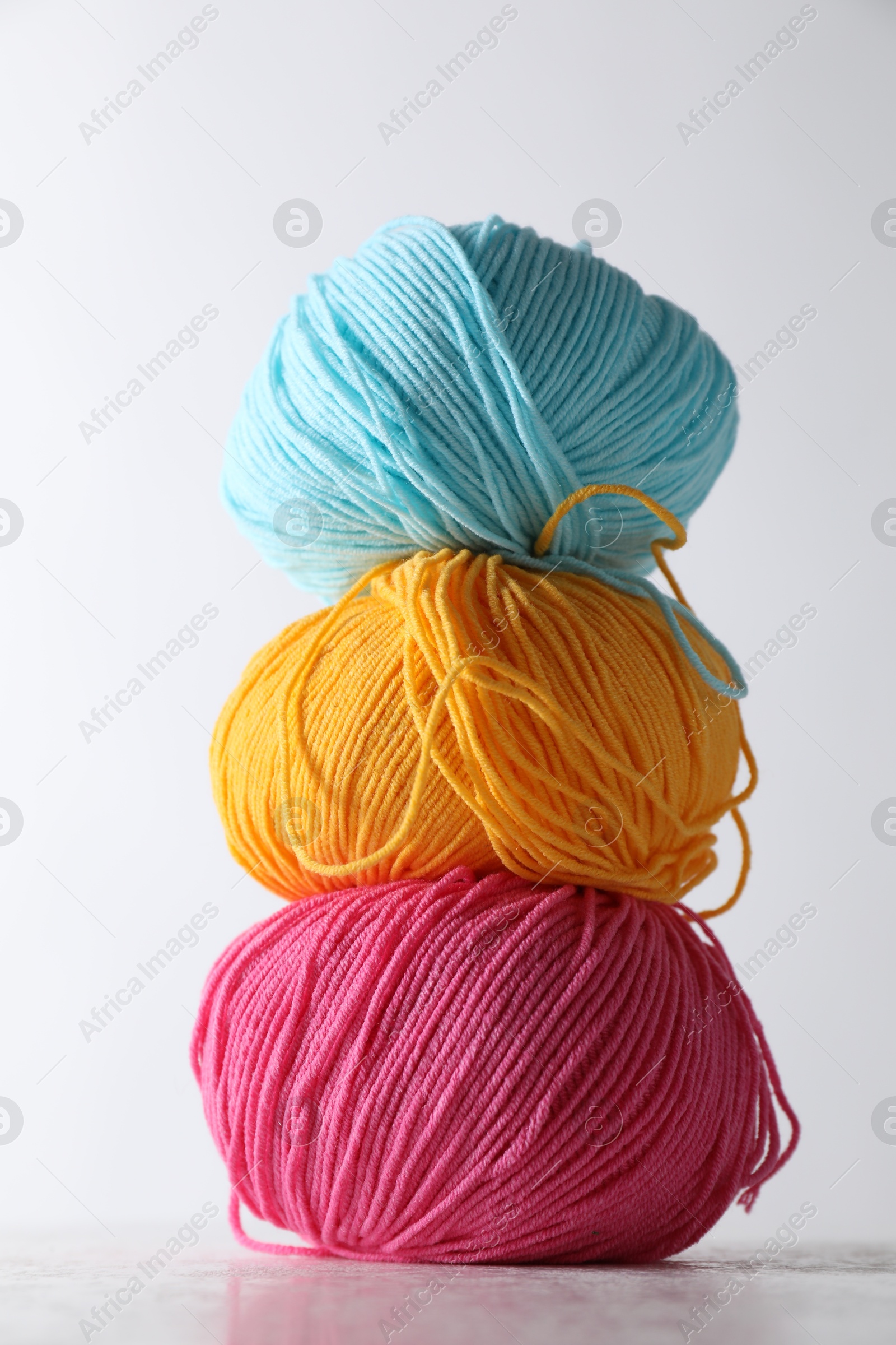 Photo of Many soft skeins of yarn on light grey background