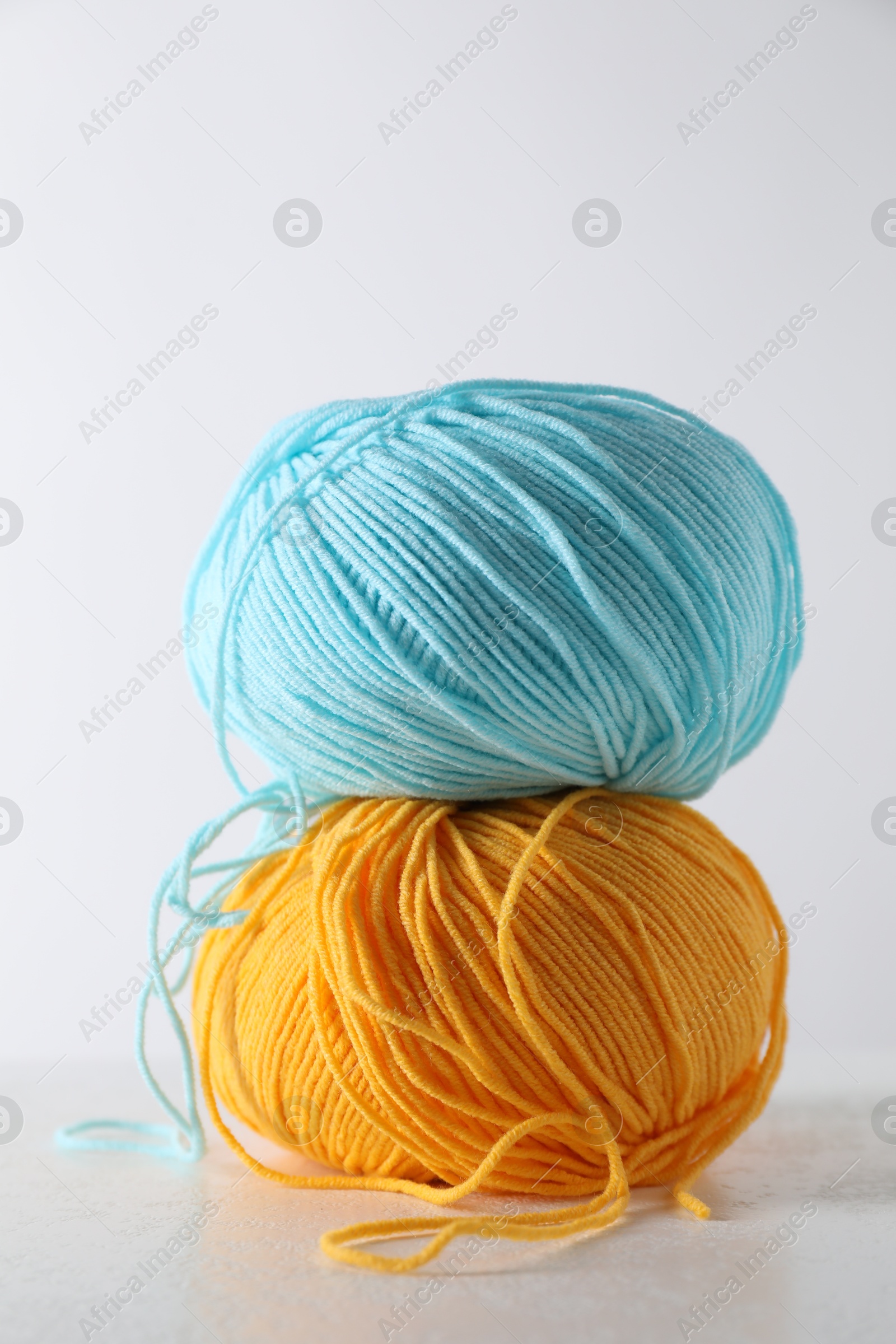 Photo of Two soft skeins of yarn on light grey background