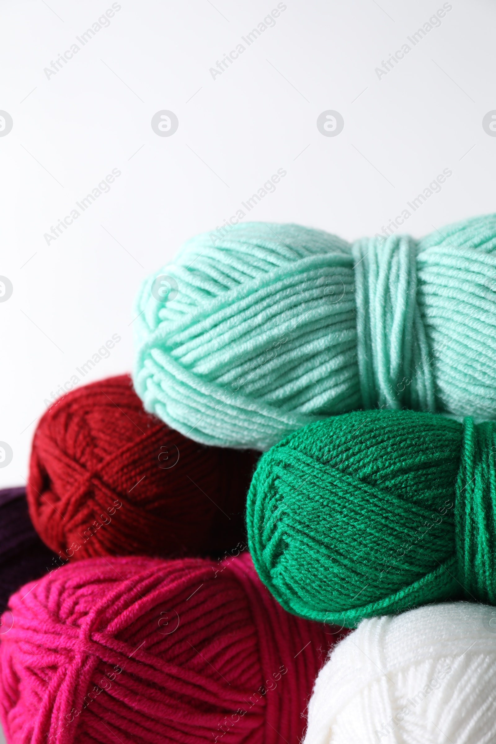 Photo of Many soft skeins of yarn on light grey background