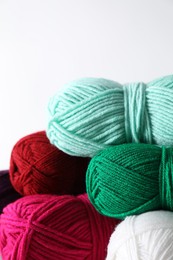 Photo of Many soft skeins of yarn on light grey background