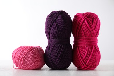 Many soft skeins of yarn on light grey background