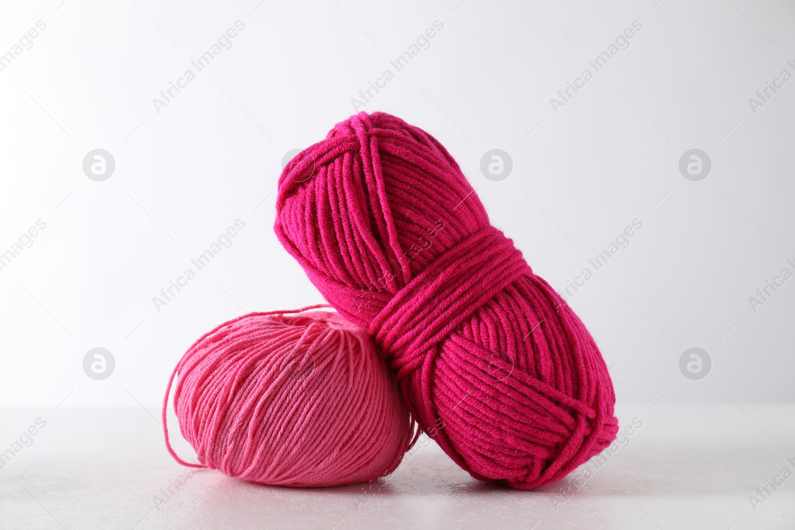 Photo of Two soft skeins of yarn on light grey background